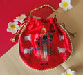 A vibrant red silk potli bag featuring a printed illustration of Shreenathji surrounded by cows, accented with pearl trim along the edge and a golden beaded handle.