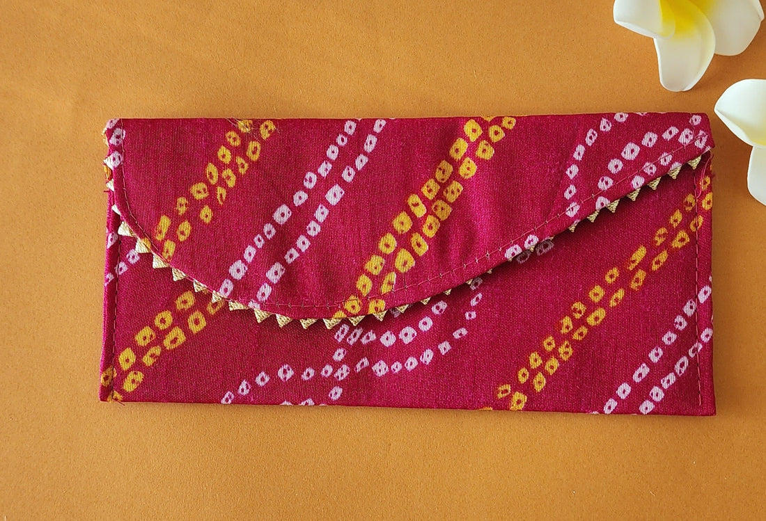 A Bandhni Design Shagun Envelope with traditional tie-dye patterns in pink, yellow, and white colors.