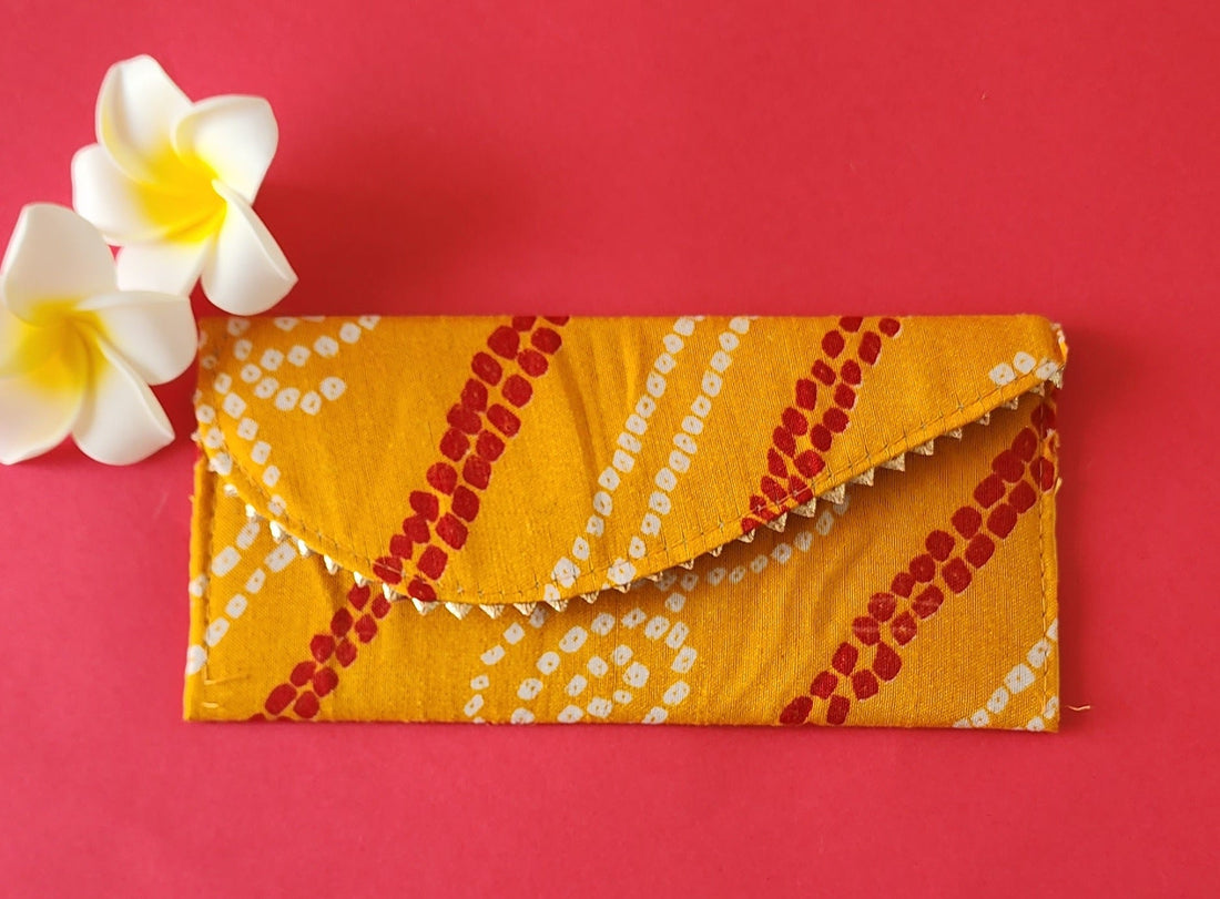 A Bandhni Design Shagun Envelope with traditional tie-dye patterns in pink, yellow, and white colors.