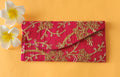Pink color embroidered envelope with two flowers around it