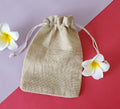 A beige Potli gift bag with a drawstring closure,