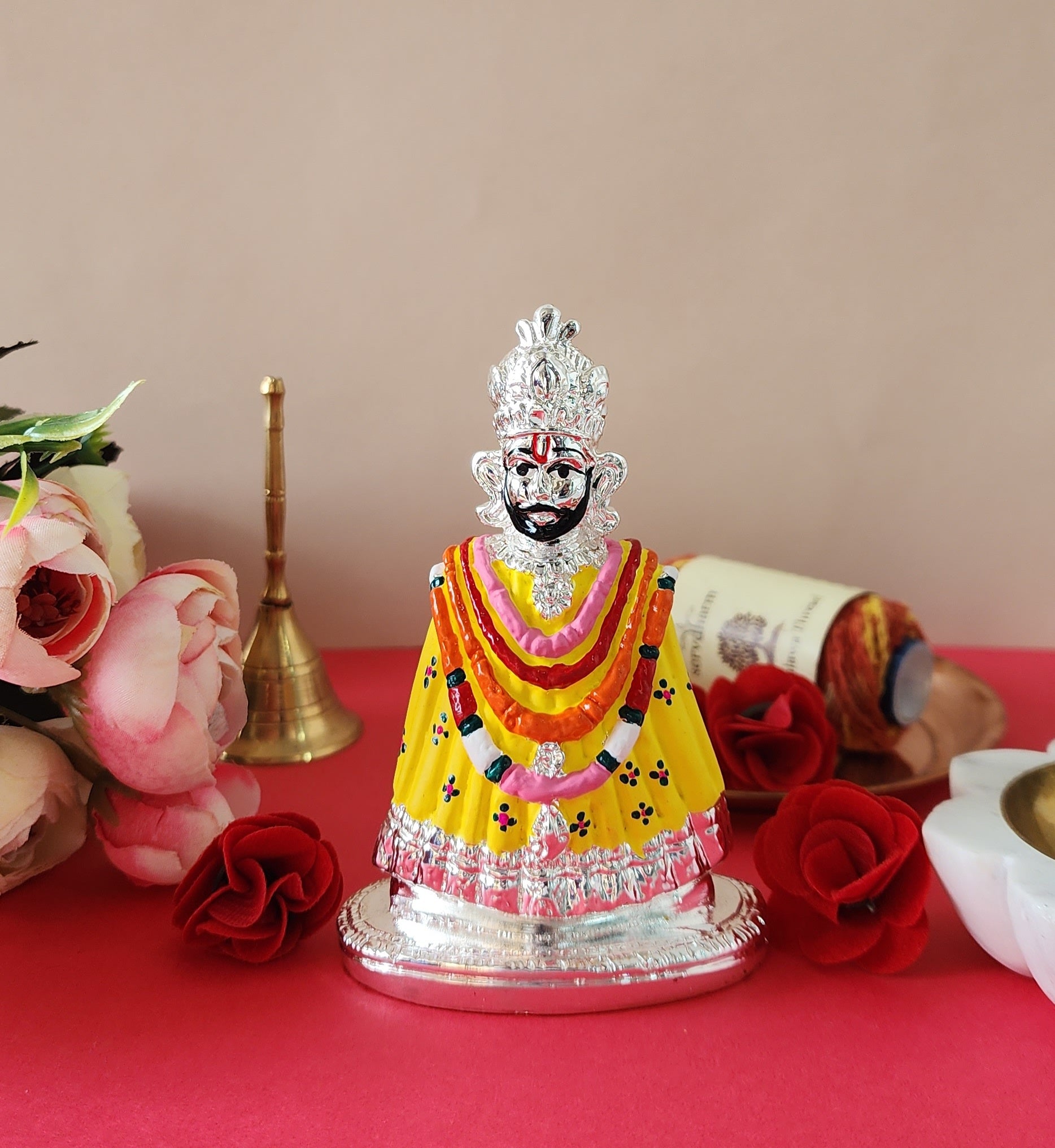 Khatu Shyam Ji Idol with red flowers around it