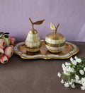 A decorative brass set featuring apple and pear shaped containers with tray