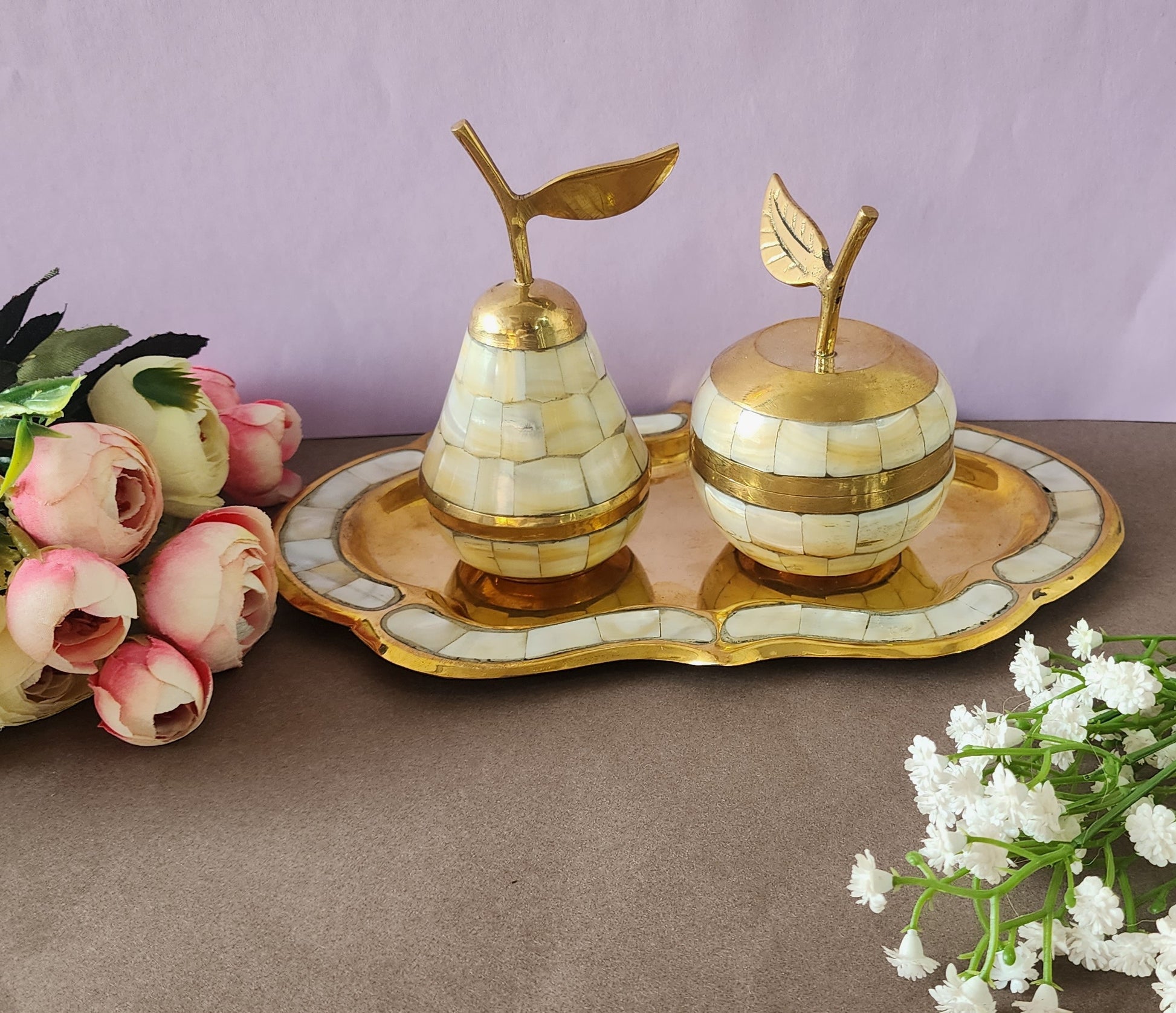 A decorative brass set featuring apple and pear shaped containers with tray, inlaid with mother of pearl