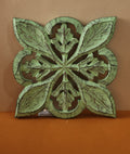 Wooden Carved Trivet in a sleek green finish stand at wall