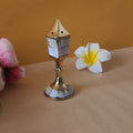 incense holder with flowers behind it