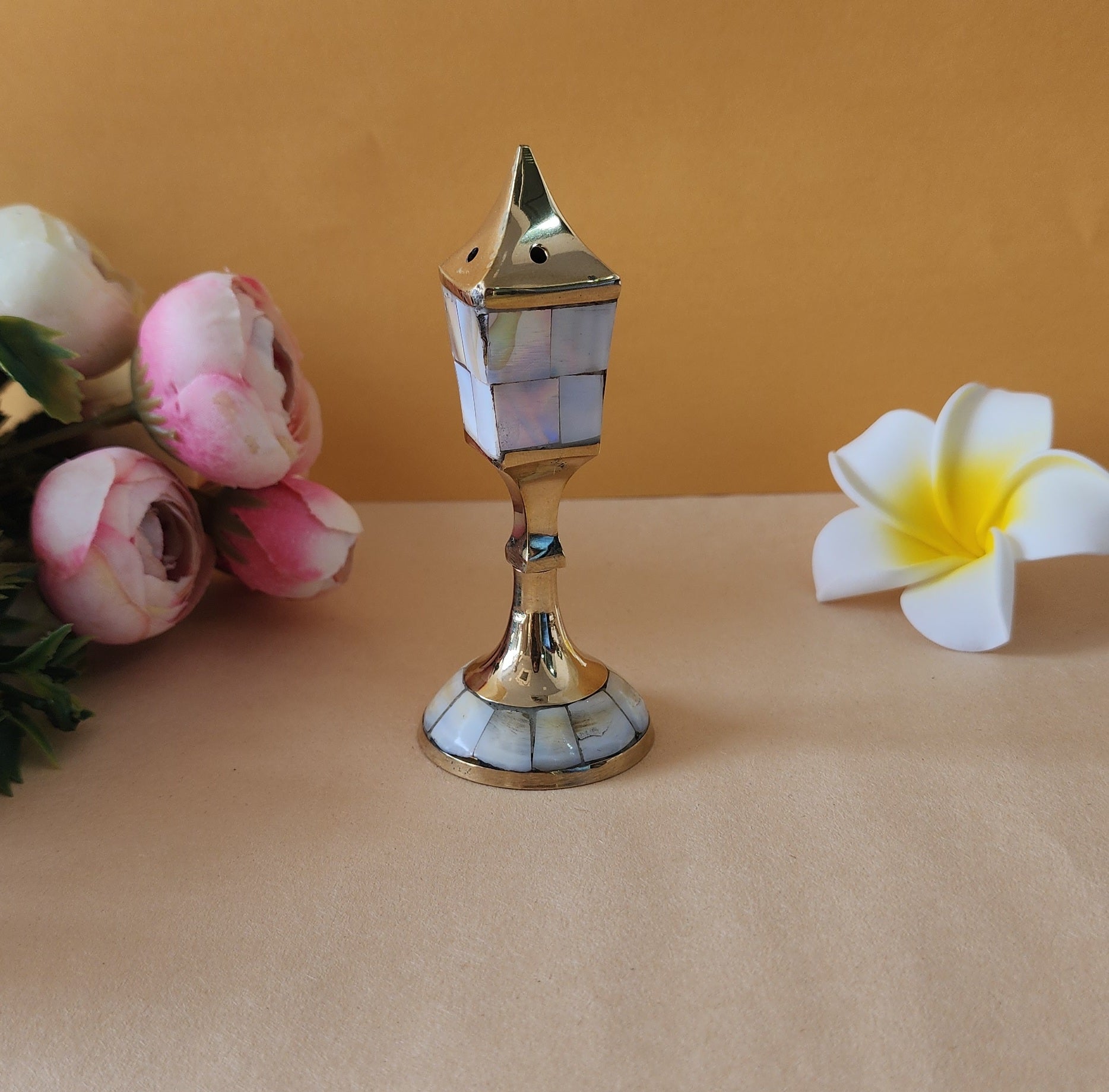 incense holder agarbatti holder with white and rose behind it