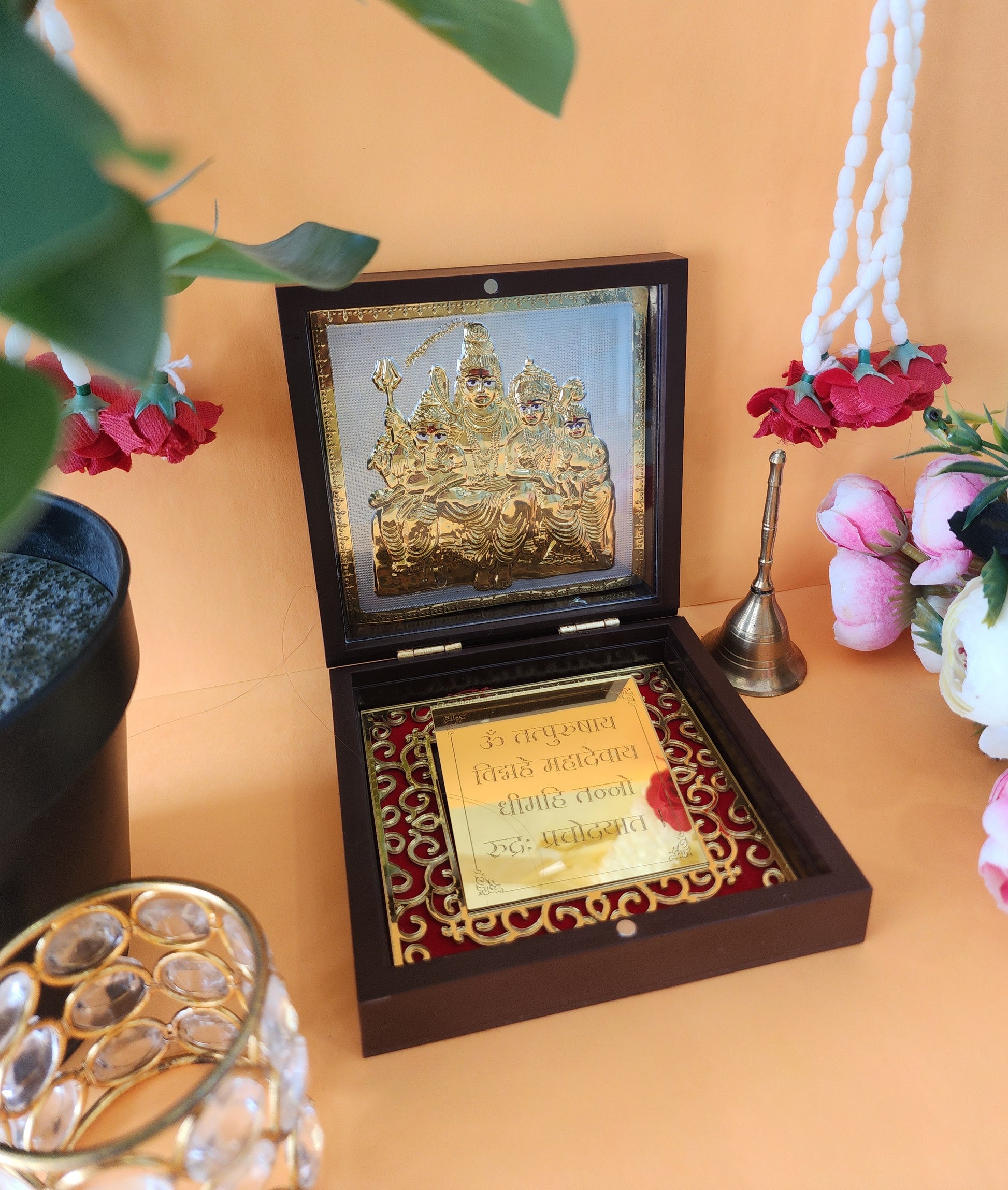 A gold-plated Shiva Parivar idol set in a decorative open wooden box with a gold plaque inscribed with a mantra. The set appears to be a religious or gifting item, suitable for home temples or as a festive offering.