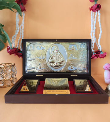 A gold-plated Lord Shiva Pocket Temple, featuring a central idol surrounded by smaller deities or symbols, displayed in an open wooden box with a red velvet interior and two additional gold-colored plaques with "Om" symbols.