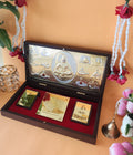 A decorative wooden box with a gold-toned interior featuring an embossed image of Lord Shiva and other deities, alongside smaller golden plaques inscribed with