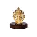 A 3-inch Ganesha idol with a Kalpavriksha Tree is shown. The idol is a cream color with gold accents, seated on a glossy, dark wooden base.