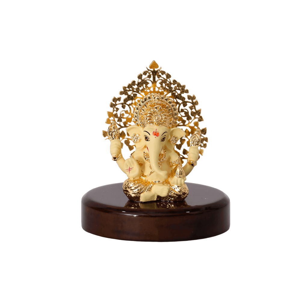 A 3-inch Ganesha idol with a Kalpavriksha Tree is shown. The idol is a cream color with gold accents, seated on a glossy, dark wooden base.