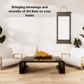 A golden 3D model of Shri Ram Mandir Ayodhya Temple on a coffee table in a modern living room, with text about bringing blessings and serenity to your home.
