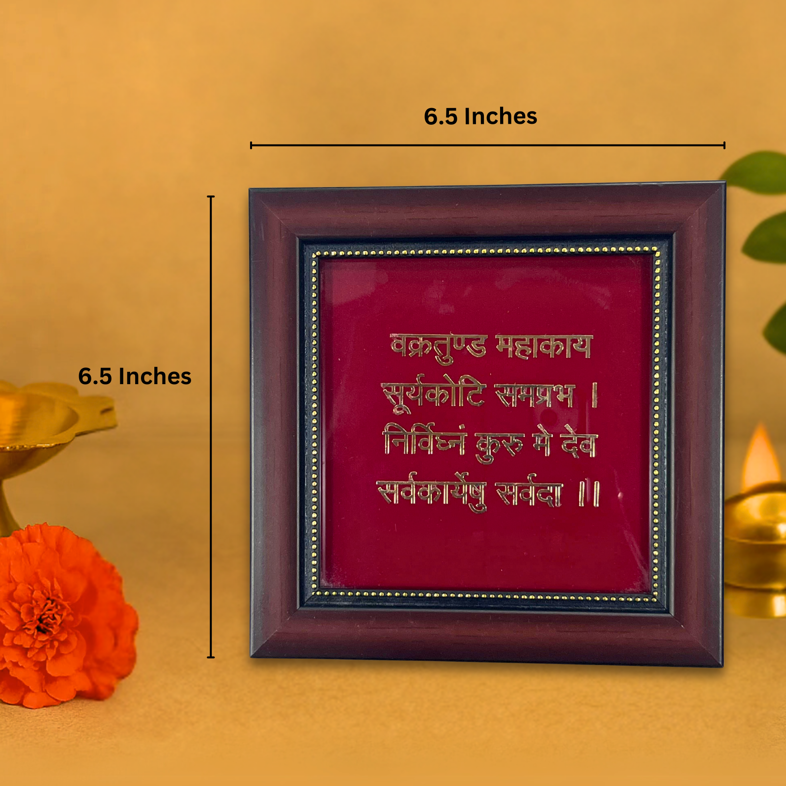 A framed brown and red wall art featuring the Sanskrit mantra 'Vakratunda Mahakaya Suryakoti Samaprabha Nirvighnam Kurumedev Sarvakaryeshu Sarvada' in gold-colored text, with its dimensions of 6.5 inches by 6.5 inches indicated by measurement lines.