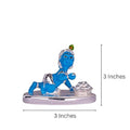 A blue, 3-inch tall and wide idol of Bal Krishna (child Krishna) in a crawling pose, holding a sweet or butter ball, with a pot of sweets beside him. The idol has a silver base and accents.