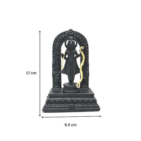 A black idol of Ram Lalla, depicting Lord Rama as a five-year-old child, standing with a golden bow and arrow, adorned with garlands of red and white flowers in the background and yellow flower petals scattered around the base.