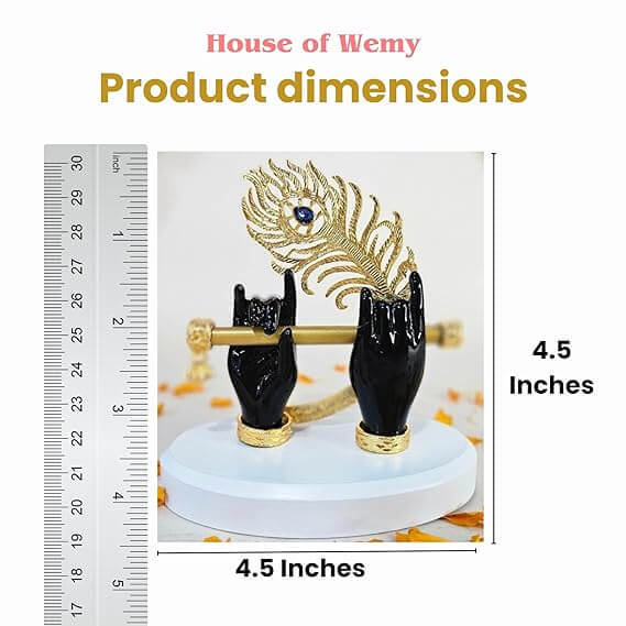 A product image displaying a black statue of Lord Krishna's hands holding a golden flute and an ornate golden peacock feather with a blue gem detail, standing on a white base. A ruler on the left side and text on the right side indicate the product dimensions as 4.5 inches. The top of the image also displays "House of Wemy" and "Product dimensions" text.