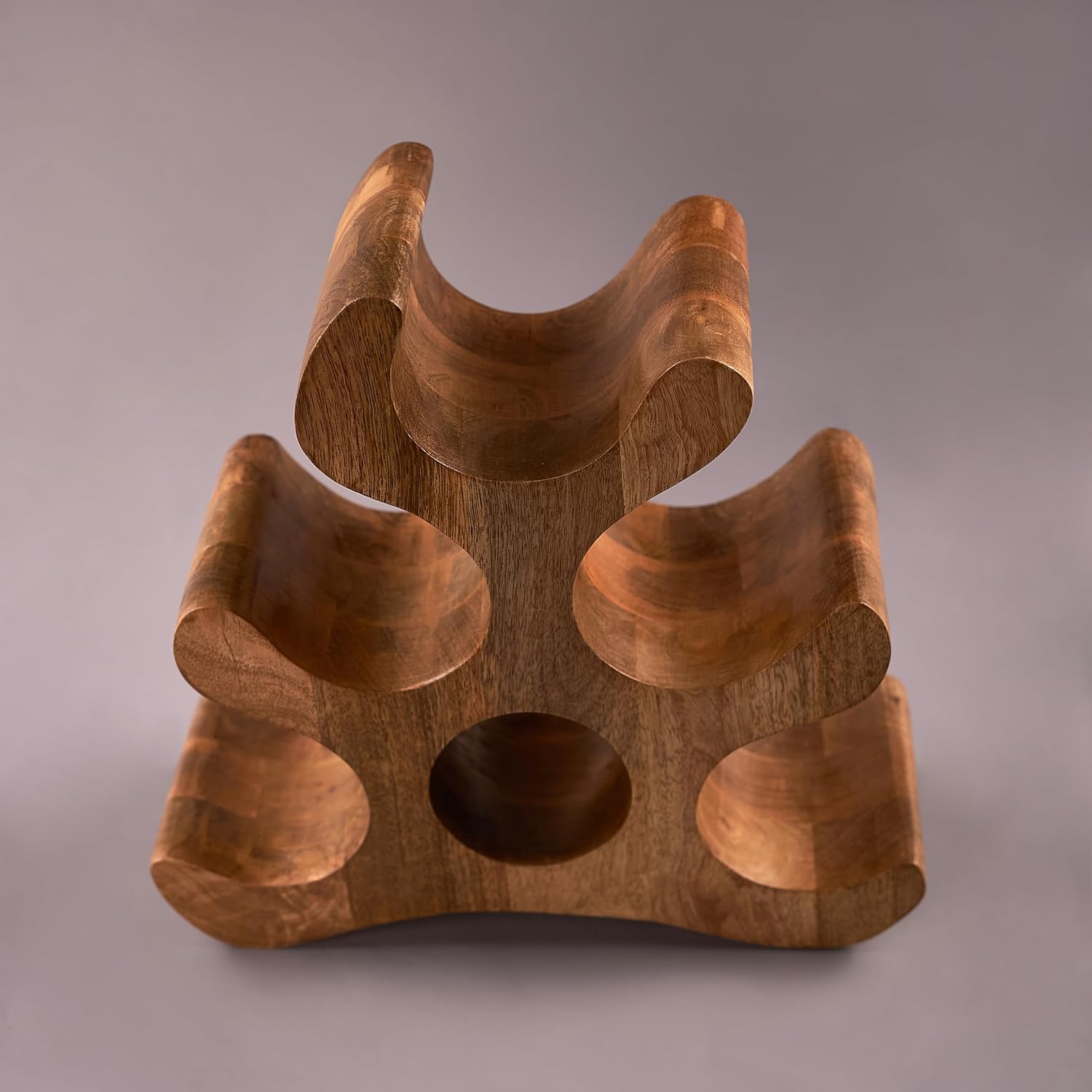 A wooden carved wine bottle holder with intricate carvings, designed to store wine bottles.