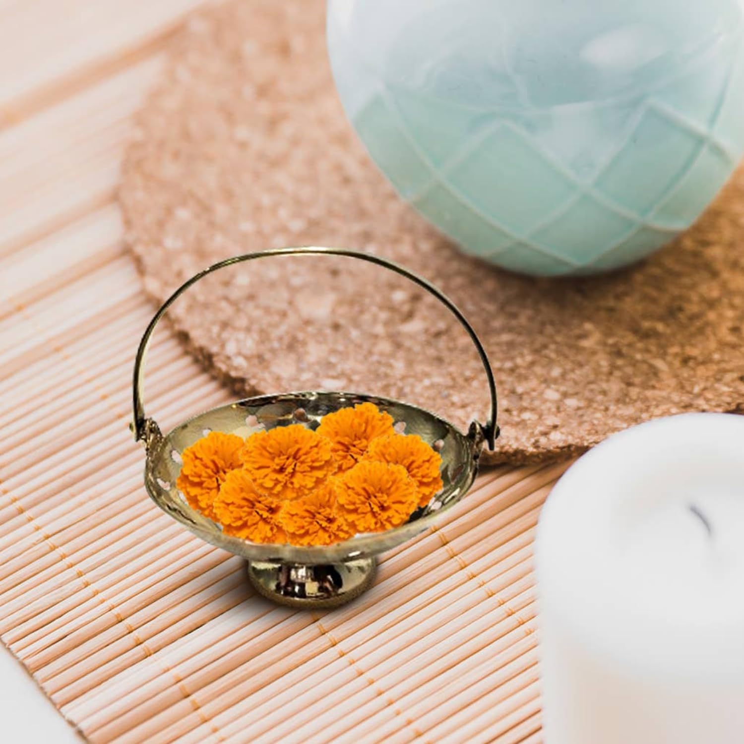 Brass Flower Basket with orange flowers in it