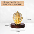 A gold-colored Ganesha idol on a dark brown circular base, with the brand name