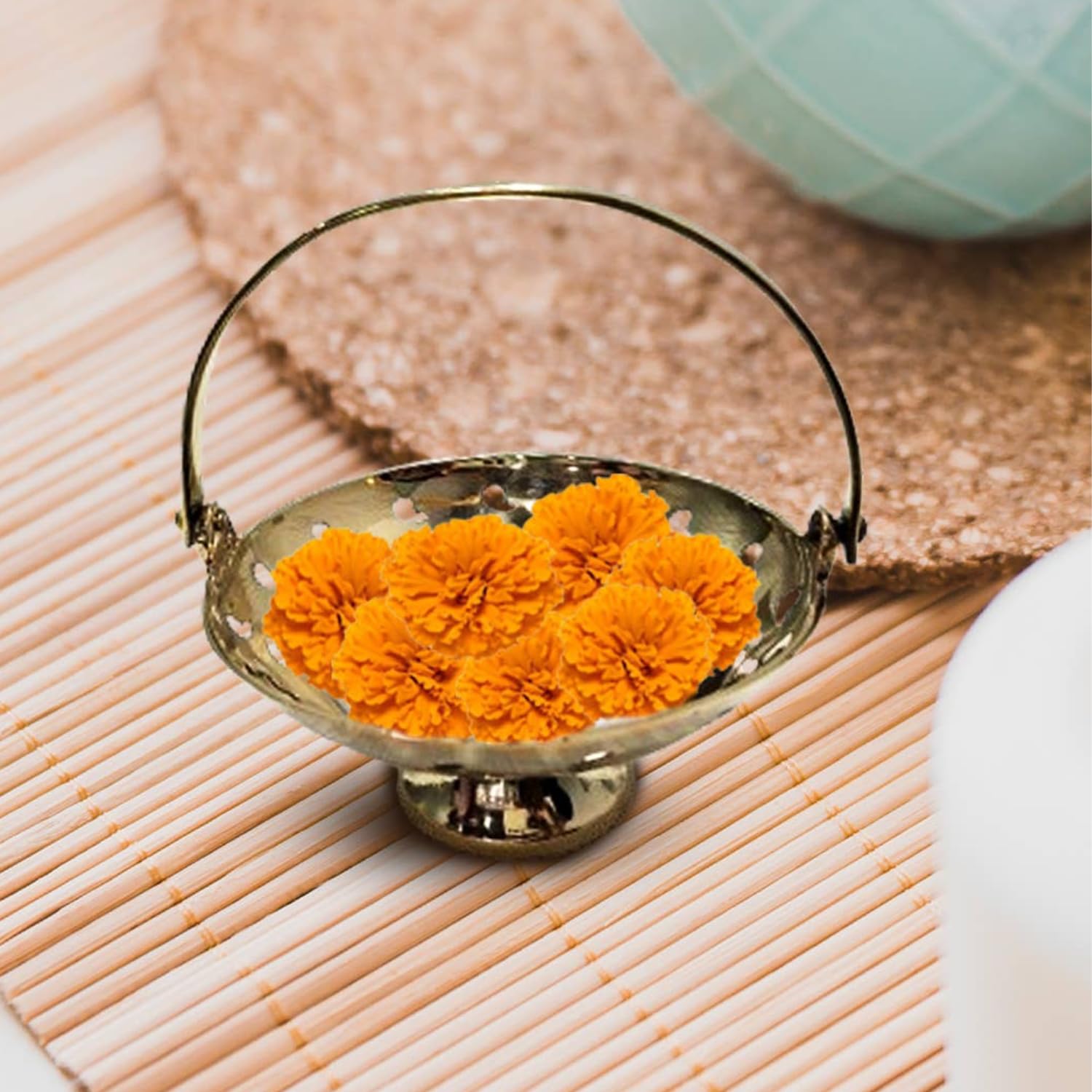 Brass Flower Basket with orange flowers in it on wooden floor