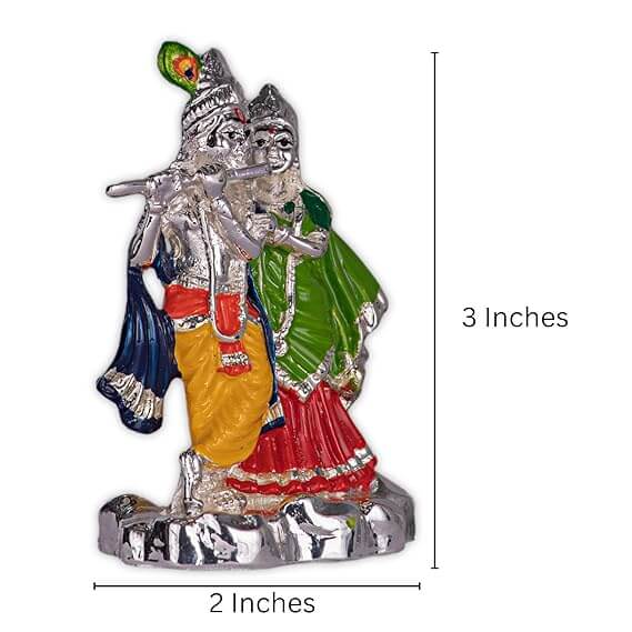 A silver-plated Radha Krishna idol, featuring Krishna playing the flute with Radha beside him, with colorful details on their attire. The idol measures 3 inches in height and 2 inches in width.