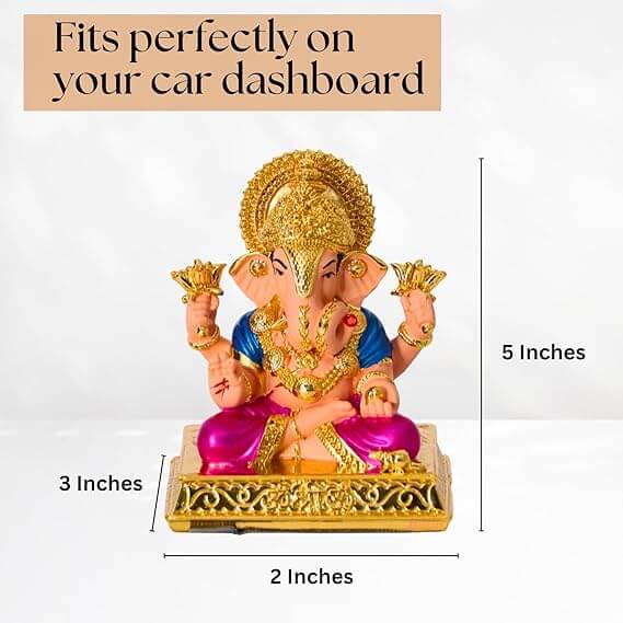 A Dagdushet Ganesha car idol is shown, featuring a light pink skin tone, a blue tunic, and a shiny magenta dhoti. The idol, which is 5 inches tall, is seated on an ornate golden base that is 3 inches deep and 2 inches wide. The image also states that the idol "Fits perfectly on your car dashboard".