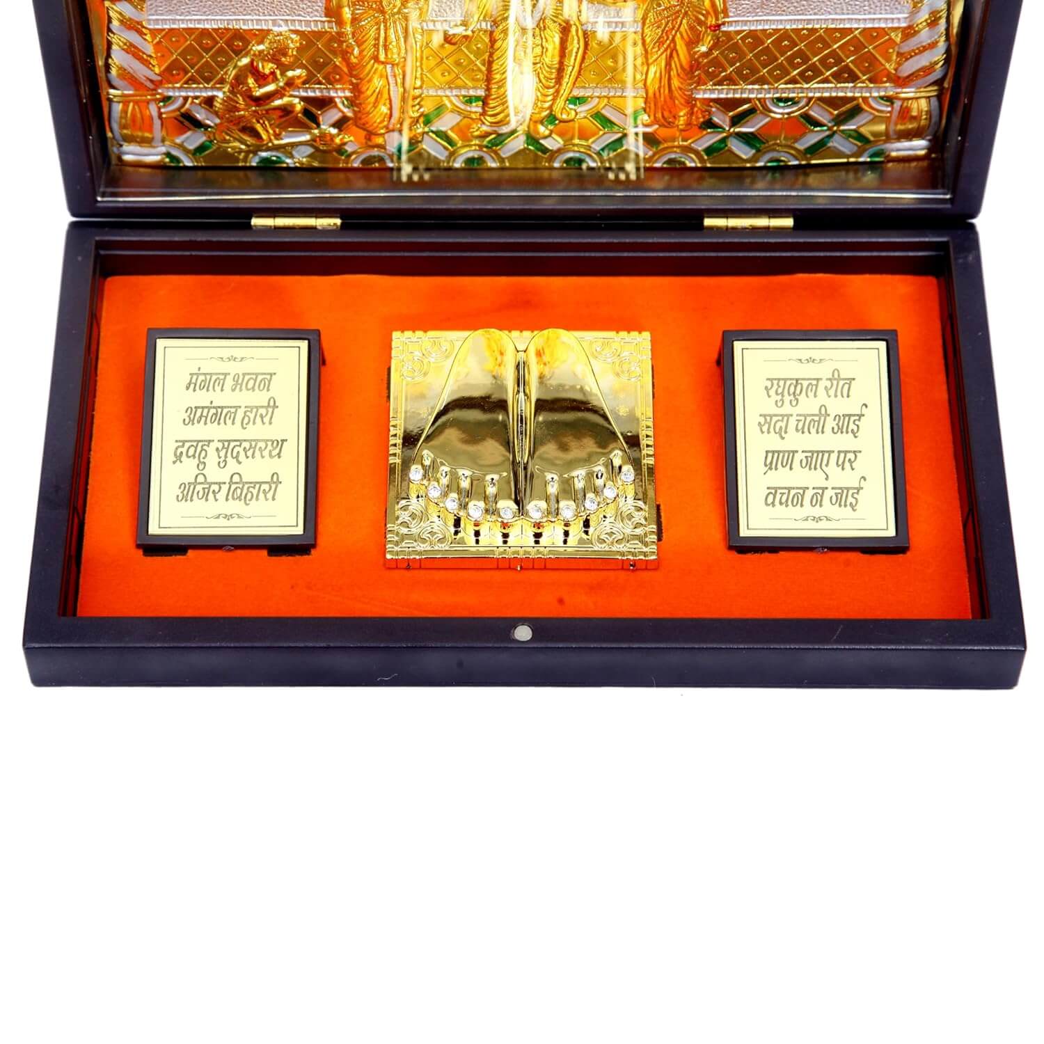 An open, dark wooden box lined with orange velvet, containing a golden Ram Darbar Pocket Temple. The temple features golden figurines of Lord Rama, Sita, Lakshmana, and Hanuman. On either side of the central temple, there are rectangular golden plaques with Hindi text inscribed in black, one starting with "मंगल भवन अमंगल हारी" and the other with "रघुकुल रीत सदा चली आई."