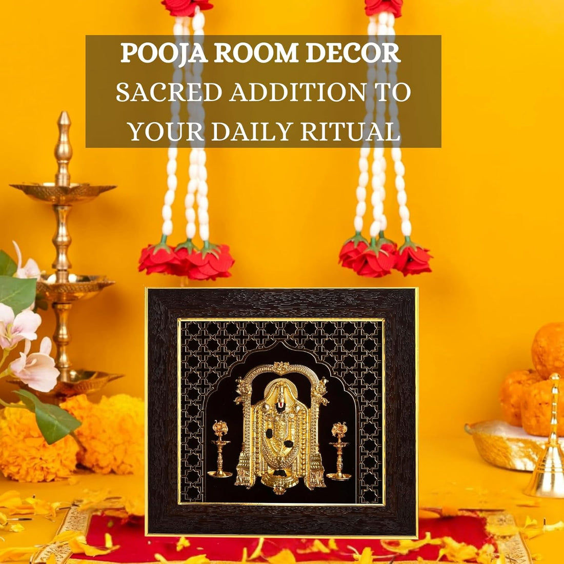 A gold-plated Lord Balaji photo frame with a dark, ornate border, featuring a detailed golden depiction of the deity, placed against a warm yellow-orange background with red flowers and petals, alongside traditional brass lamps.