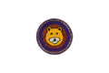A single round Beaded Coasters - Safari Theme coaster featuring a yellow and white beaded lion's face with a red and orange mane. The outer edge of the coaster is decorated with concentric rings of purple and gold beads against a white background.