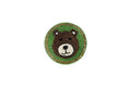 A single round Beaded Coasters - Safari Theme coaster, featuring a bear's face made of brown and white beads, set against a green beaded background with a gold-colored beaded border.