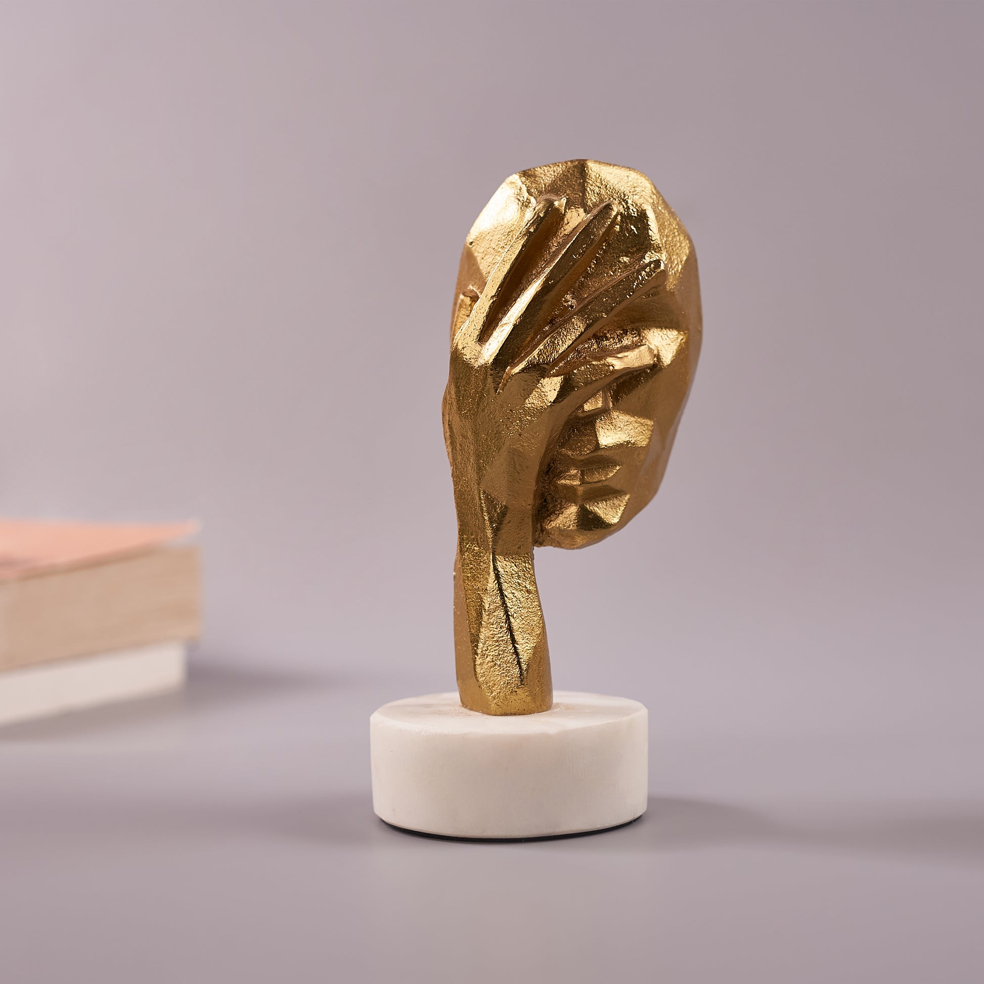 single Antique Face Figurine with his hand on face