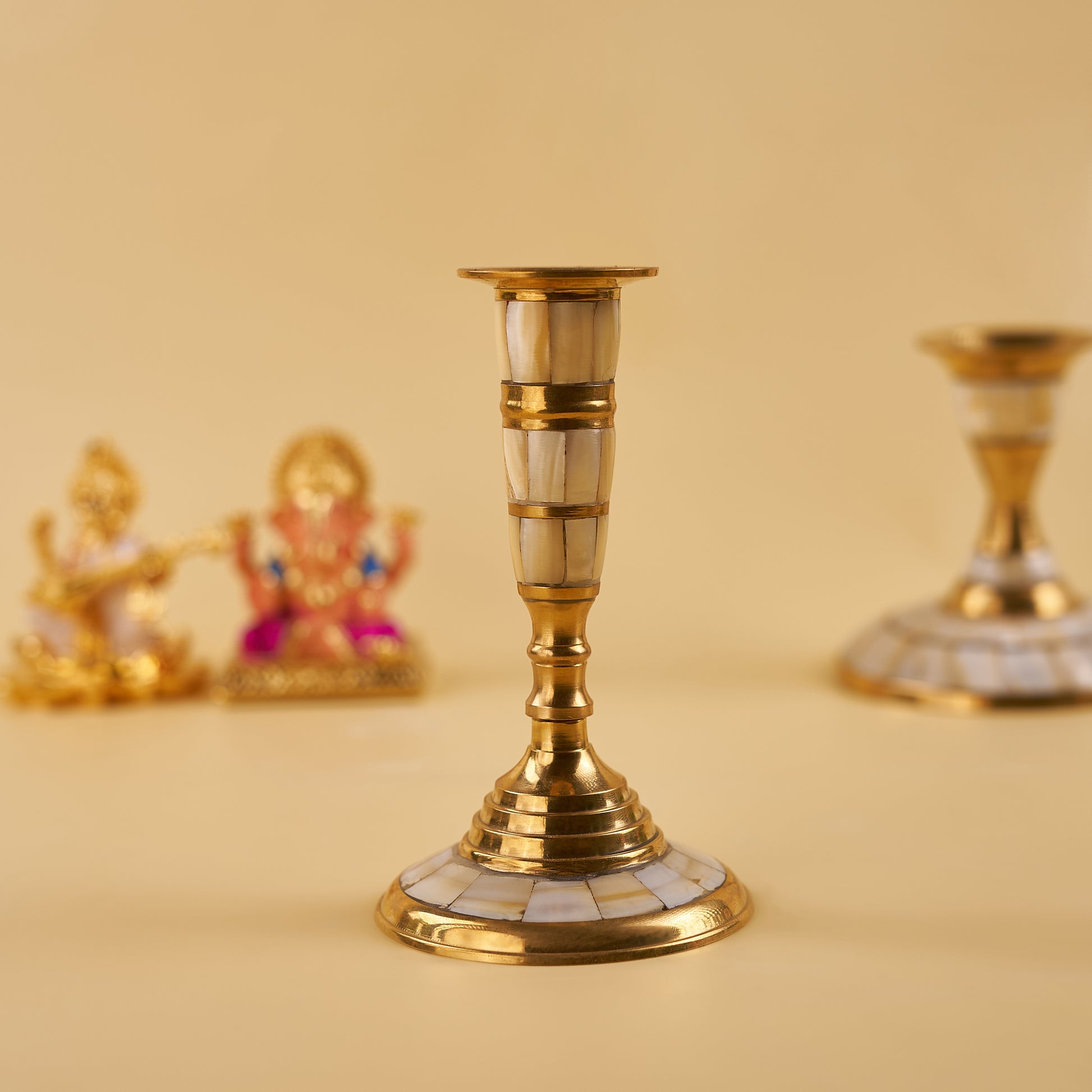 Single Candle Holders with ganesh laxmi idols behind it