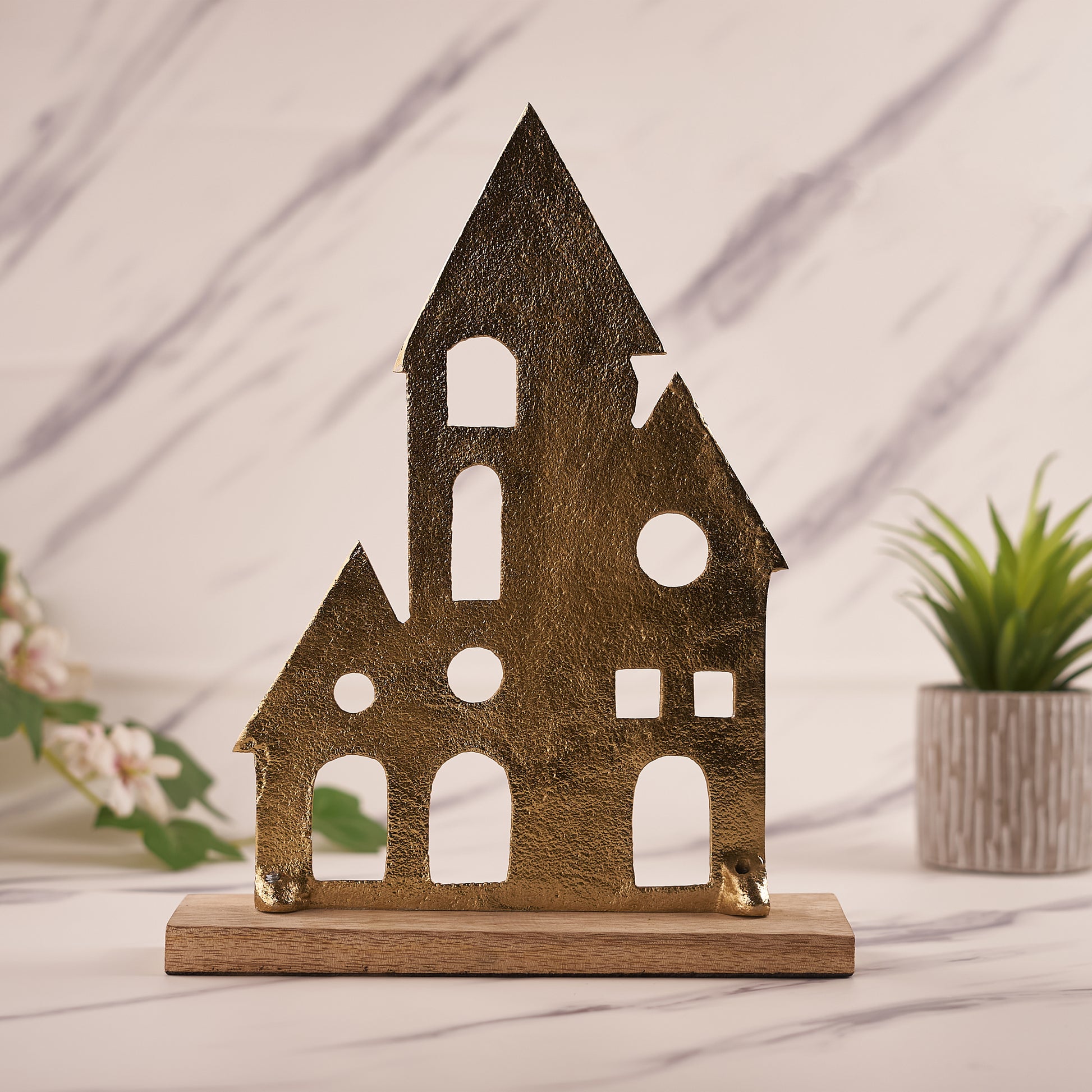 Brass House Figurine with Wooden Base with tree pot behind it