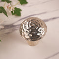 A decorative mushroom with a silver hammered pattern on the top cap, upper angel photo
