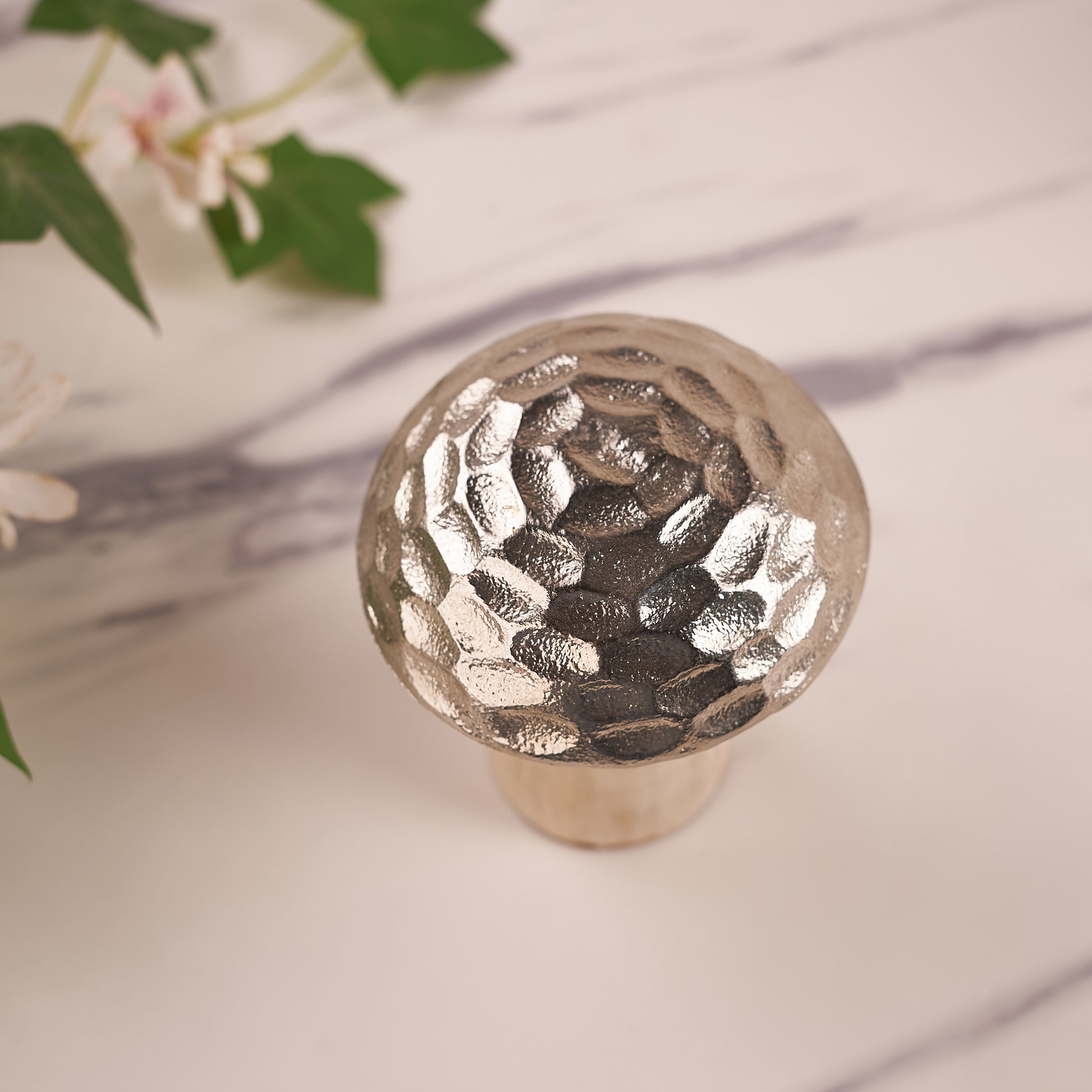 A decorative mushroom with a silver hammered pattern on the top cap, upper angel photo