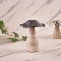 A silver mushroom-shaped decorative metal