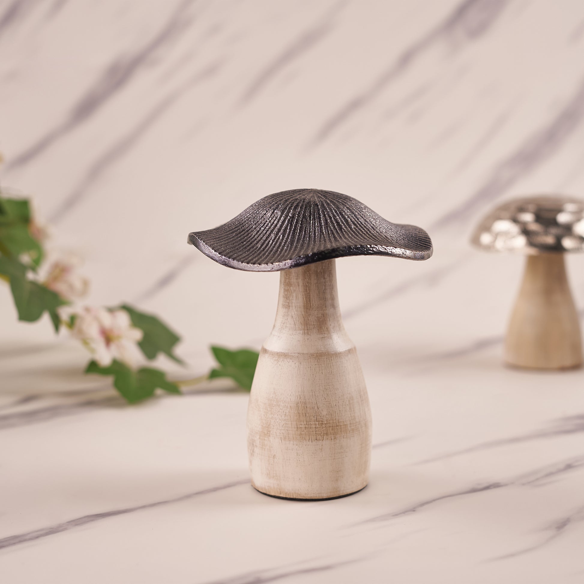 A silver mushroom-shaped decorative metal