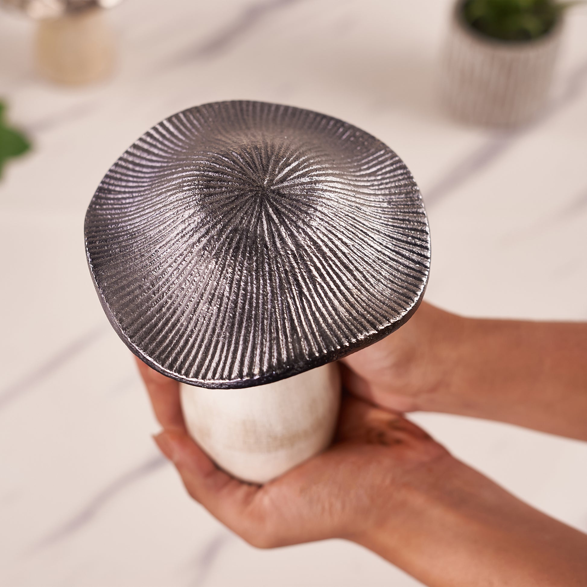 A silver mushroom-shaped decorative metal top angel photo
