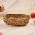 Long Oval Rattan Basket with apples behind it