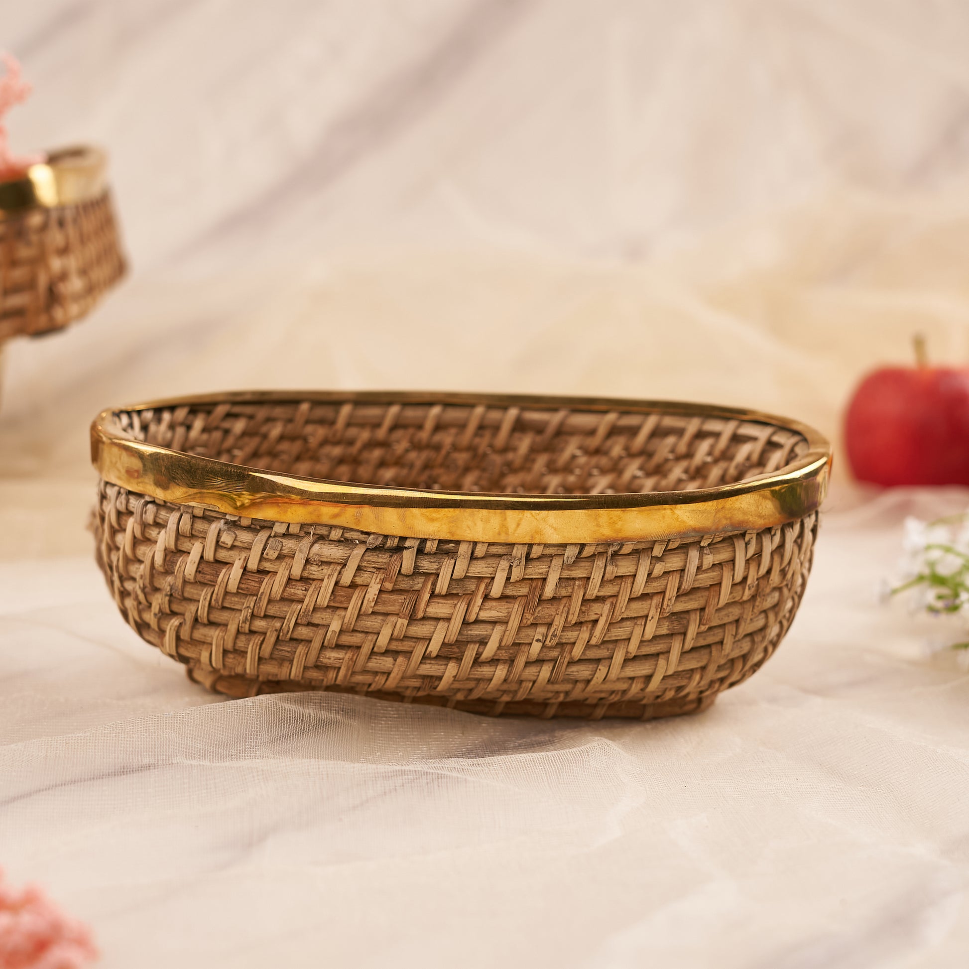 Long Oval Rattan Basket with apples behind it