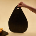one hand carring black serving platter
