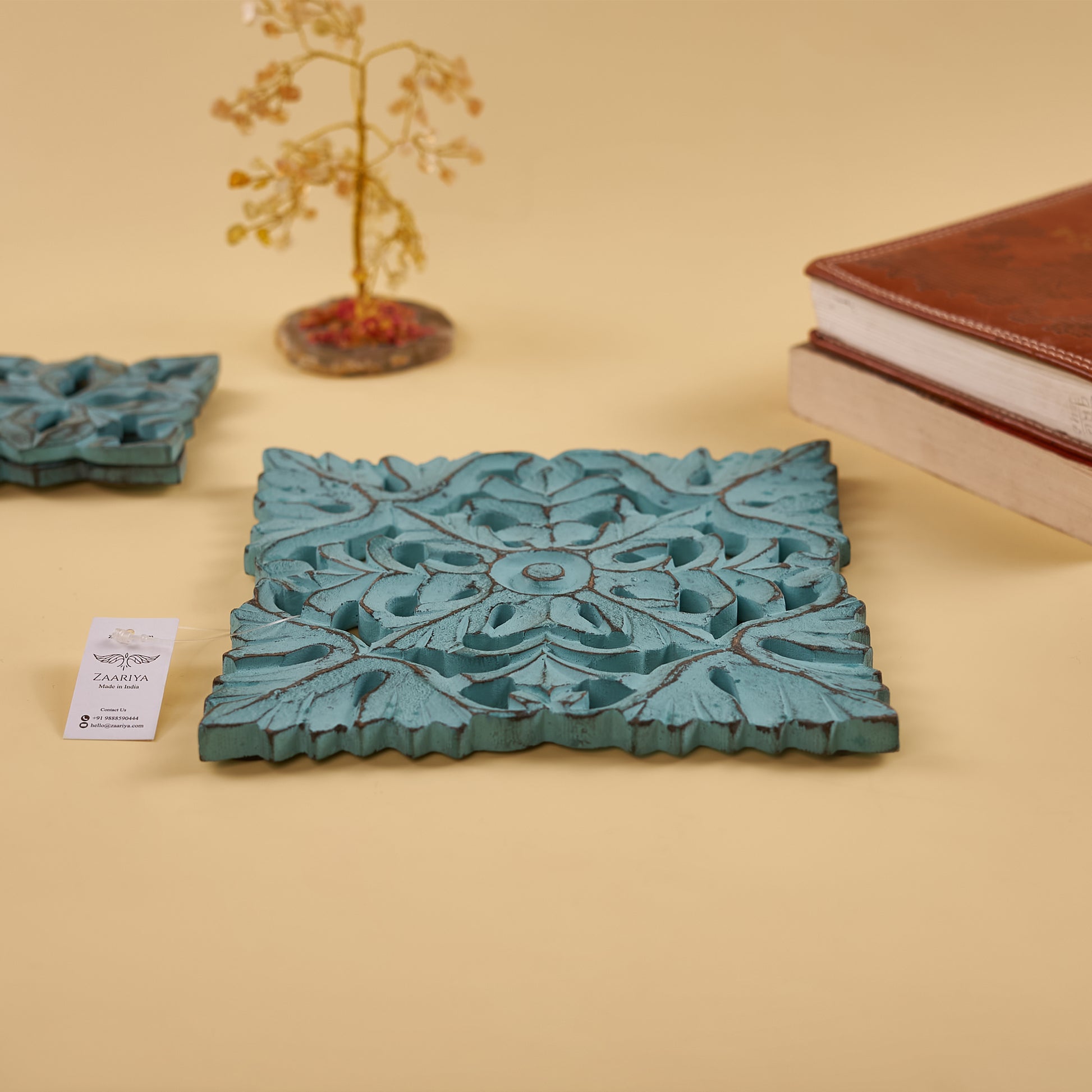 handcrafted wooden trivets​ with tree behind t