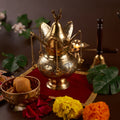 brass lota on the red chariot with flowers and sweeet around it