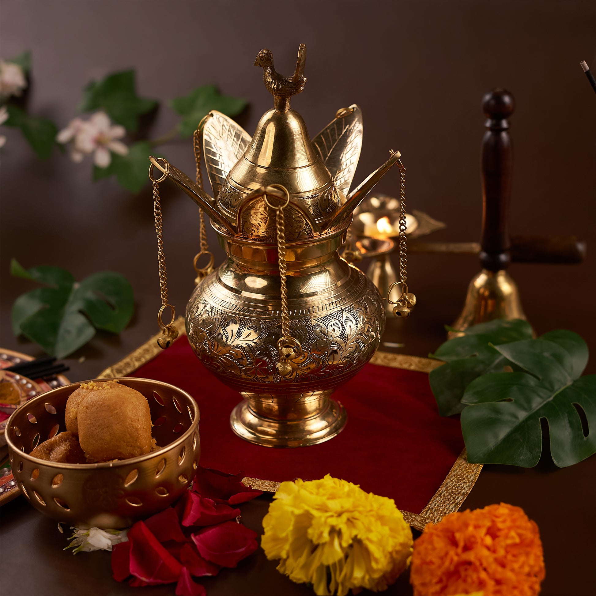 brass lota on the red chariot with flowers and sweeet around it
