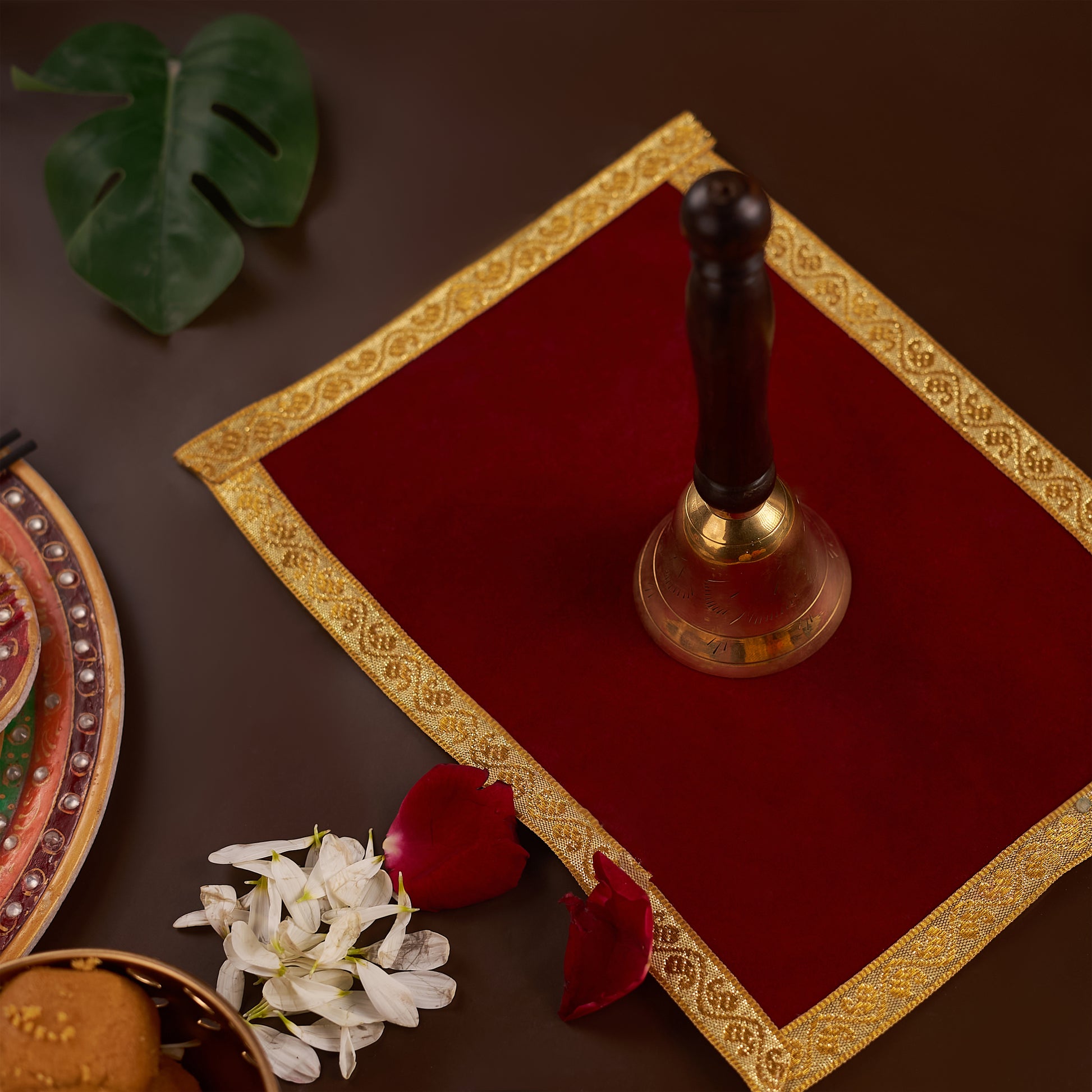 Brass Bell with Wooden Handle on red carpet