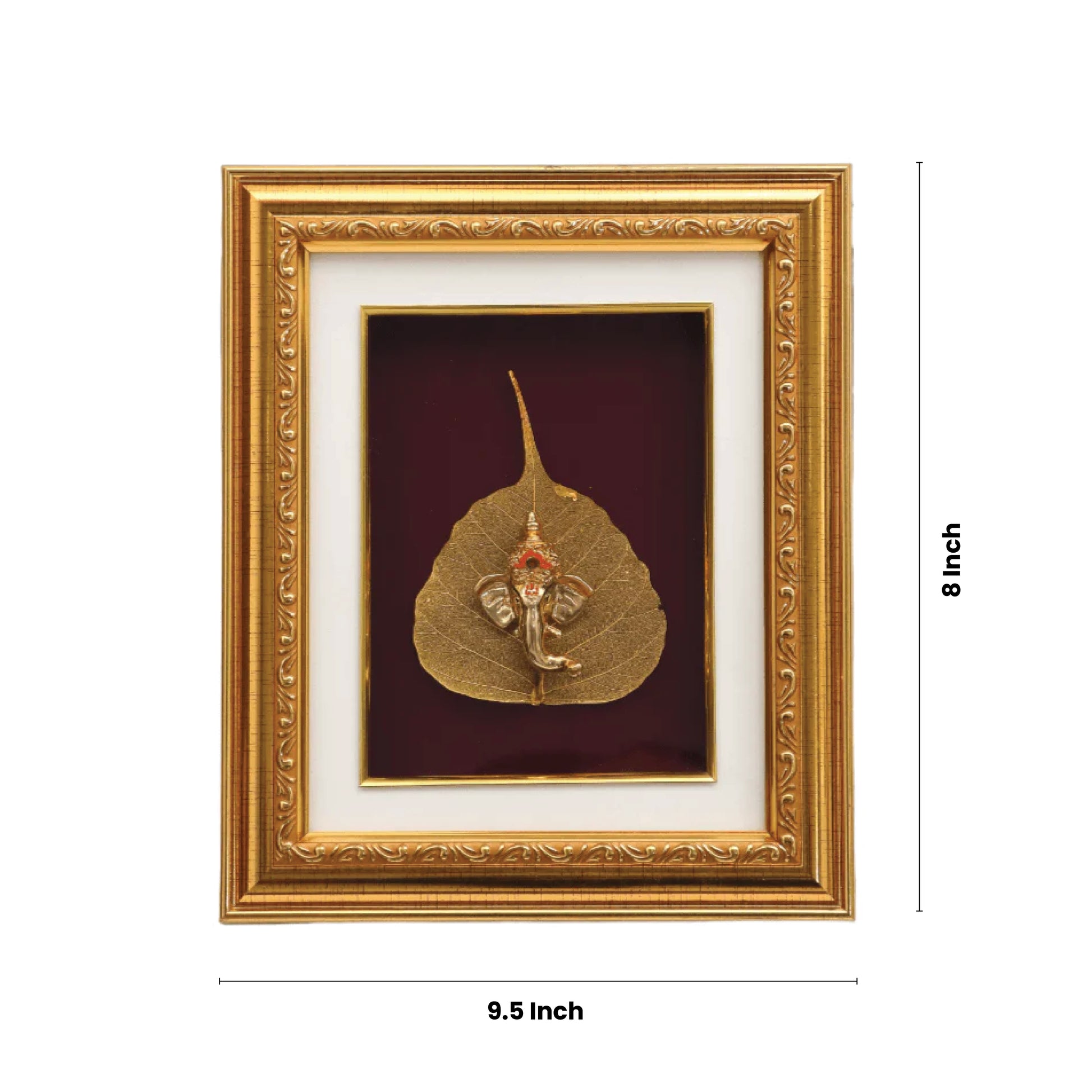 A golden-framed art piece featuring a metallic or gold-plated idol of Lord Ganesha seated on a golden leaf, possibly a Peepal leaf, set against a maroon background within the frame. The frame's dimensions are indicated as 8 inches (height) and 9.5 inches (width).