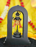 A finely detailed black statue of Ram Lalla, depicting Lord Ram as a young child, standing with a golden bow and arrow in a temple setting.