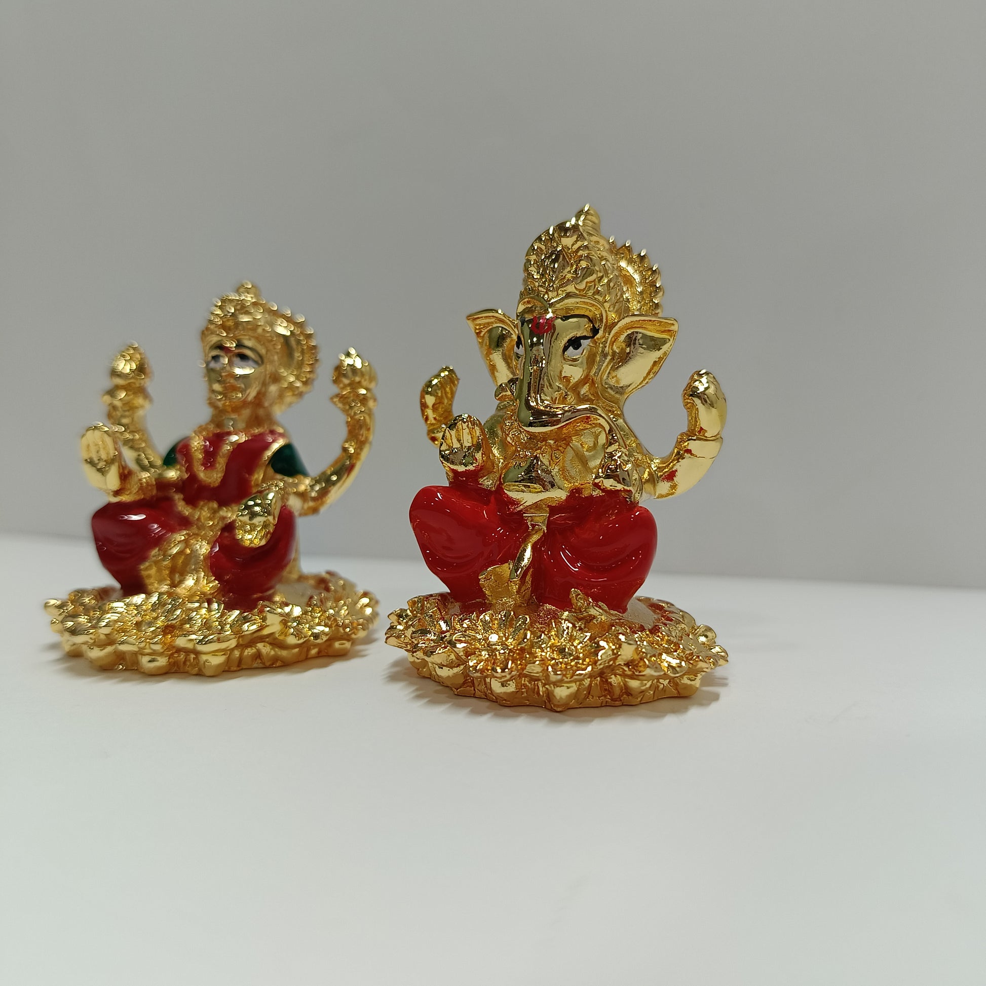The image displays a set of gold-plated idols featuring the Hindu Goddess Lakshmi and Lord Ganesha, side angel photo