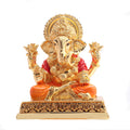 Gold palated ganesh ji  idol on the golden base with golden mushak on the base
